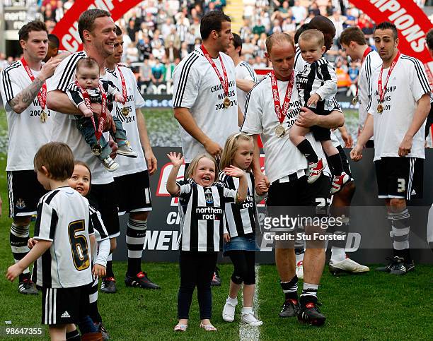 Newcastle players Kevin Nolan and Nicky Butt and their family's wave to the crowd as Newcastle are crowned champions of the Championship after the...
