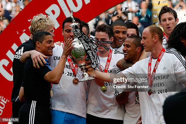 Newcastle manager Chris Hughton recieves the trophy from Nicky Butt as Newcastle are crowned champions of the Championship after the Coca Cola...