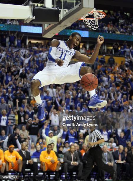 John Wall of the Kentucky Wildcats reacts after he completed a dunk against the Tennessee Volunteers during the semirfinals of the SEC Men's...