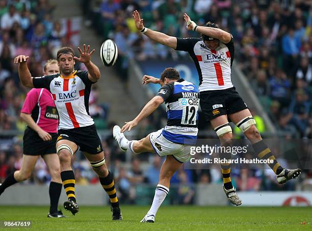 Olly Barkley of Bath threads an up field kick between Joe Worsley and George Skivington of Wasps during the Guinness Premiership St George's Day Game...