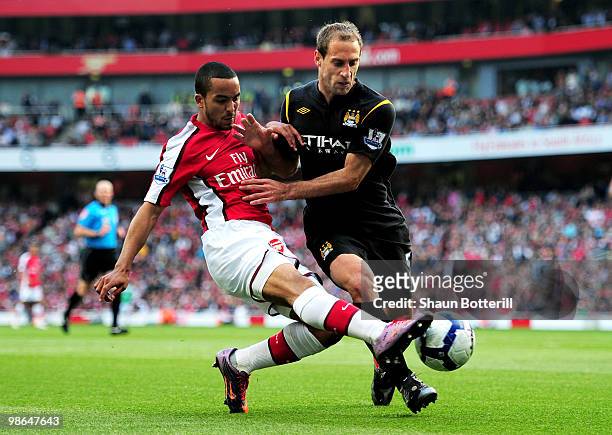 Theo Walcott of Arsenal gets in a cross past Pablo Zabaleta of Manchester City during the Barclays Premier League match between Arsenal and...