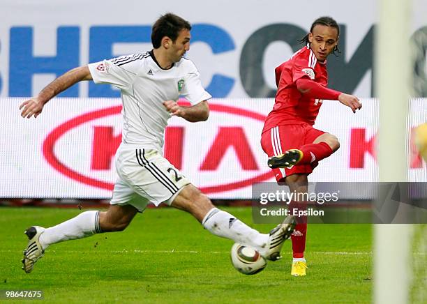 Peter Odemwingie of FC Lokomotiv Moscow battles for the ball with Georgi Dzhioyev of FC Tom Tomsk during the Russian Football League Championship...