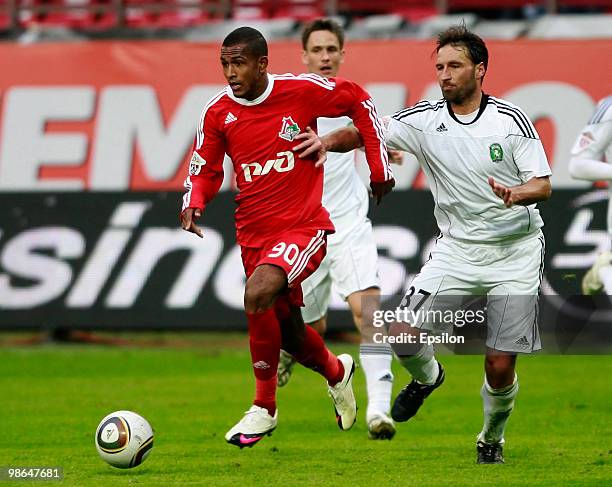 Maicon of FC Lokomotiv Moscow battles for the ball with Dorde Jokic of FC Tom Tomsk during the Russian Football League Championship match between FC...