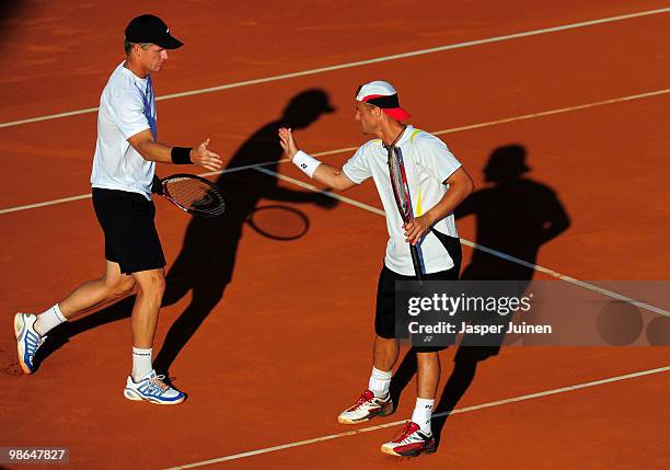 Mark Knowles of the Bahamas and Lleyton Hewitt of Australia celebrate a point over Mariusz Fyrstenberg and Marcin Matkowski of Poland during the semi...