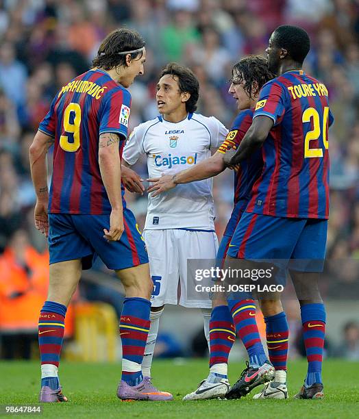 Barcelona's Swedish forward Zlatan Ibrahimovic , captain Carles Puyol and midfielder Yaya Toure from Ivory Coast argues with a Jerez' Chilian forward...