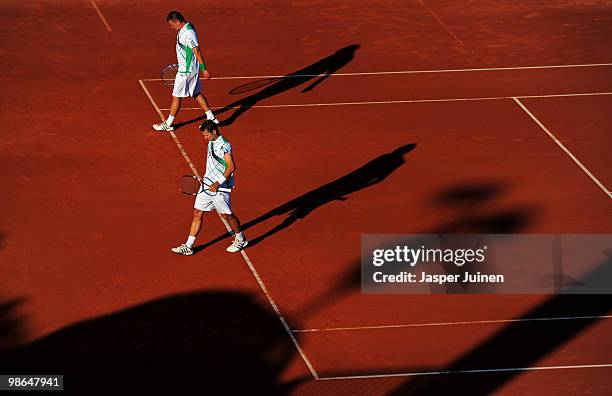 Mariusz Fyrstenberg of Poland walks flanked by his fellow countryman Marcin Matkowski during the semi final match against Mark Knowles of the Bahamas...