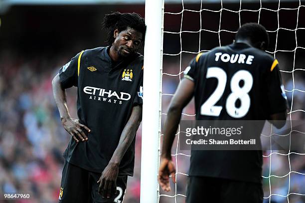 Emmanuel Adebayor of Manchester City and teammate Kolo Toure look on during the Barclays Premier League match between Arsenal and Manchester City at...