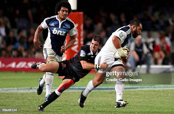 John Afoa of the Blues tries to break through the tackle of Ruan Pienaar of the Sharks during the Super 14 round 11 match between The Sharks and...