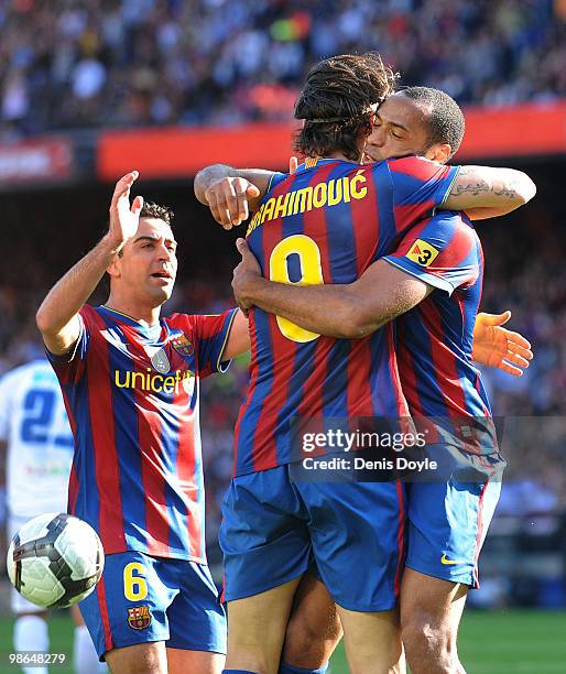 Thierry Henry of Barcelona embraces Zlatan Ibrahimovic while Xavi Hernandez looks on after Henry scored Barcelona's 2nd goal during the La Liga match...