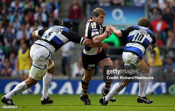 Tom Rees of Wasps tries to get past Danny Grewcock and Butch James of Bath during the Guinness Premiership St George's Day Game between London Wasps...