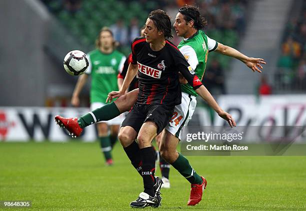 Claudio Pizarro of Bremen and Pedro Geromel of Koeln compete for the ball during the Bundesliga match between Werder Bremen and 1. FC Koeln at Weser...