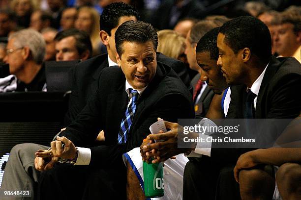 Head coach John Calipari, John Wall and assistant coach Rod Strickland of the Kentucky Wildcats talk on the bench against the Tennessee Volunteers...