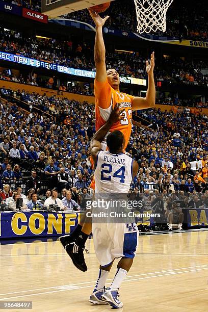 Brian Williams of the Tennessee Volunteers attempts a shot against Eric Bledsoe of the Kentucky Wildcats during the semifinals of the SEC Men's...