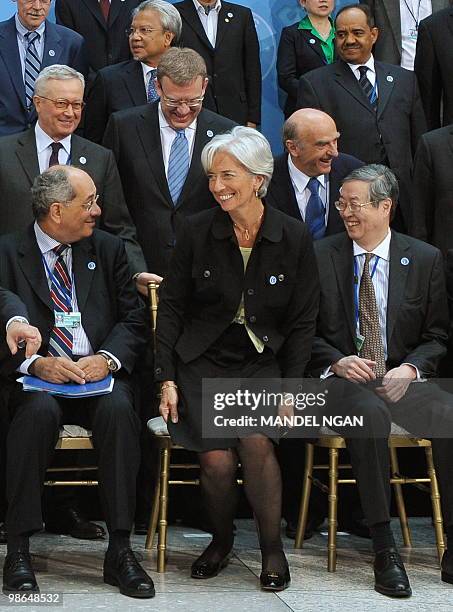 France�s Finance Minister Christine Lagarde takes her seat to pose in a group photo with from left, front row: Egypt�s Finance Minister Youssef...