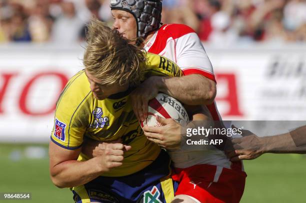 Clermont-Ferrand's player Aurelien Rougerie is tackled by a Biarritz' player during the French Top 14 rugby union match Biarritz vs. Clermont Ferrand...