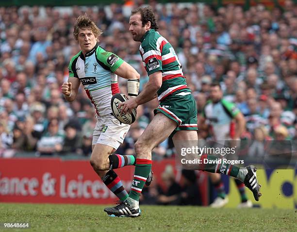 Geordan Murphy of Leicester runs with the ball watched by David Strettle during the Guinness Premiership match between Leicester Tigers and...