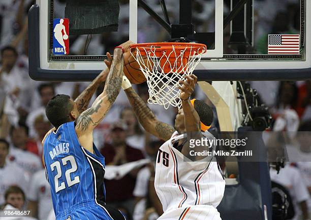 Forward Tyrus Thomas of the Charlotte Bobcats blocks a shot by forward Matt Barnes of the Orlando Magic during Game Three of the Eastern Conference...