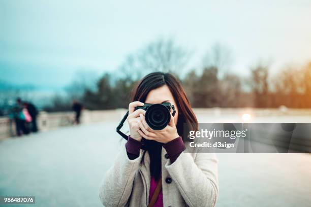 young female tourist taking pictures on the top of the mont royal park - freedom to the camera stock pictures, royalty-free photos & images