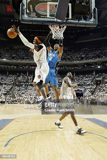 Gerald Wallace of the Charlotte Bobcats blocks against Dwight Howard of the Orlando Magic in Game Three of the Eastern Conference Quarterfinals...