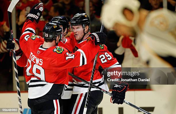 Jonathan Toews, Niklas Hjalmarsson and Bryan Bickell of the Chicago Blackhawks celebrate Hjalmarsson's 1st period goal as David Legwand of the...