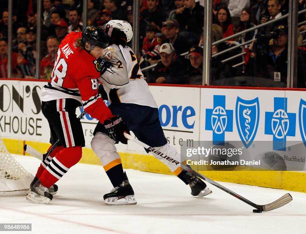 Patrick Kane of the Chicago Blackhawks battles for the puck with Dan Hamhuis of the Nashville Predators in Game Five of the Western Conference...