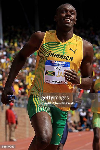 Usain Bolt of Jamaica Gold celebrates after crossing the finish line to win the USA versus The World 4 x 100-meter relay during the Penn Relays at...