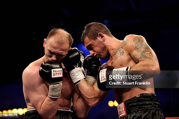 Juergen Braehmer of Germany exchanges punches with Mariano Nicolas Plotinsky of Argentina during their WBO light heavyweight fight during the...