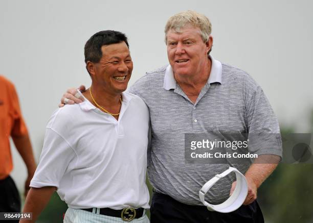 Chien Soon Lu of Taiwan and partner Andy Bean walk off the 18th green during the second round of the Legends Division at the Liberty Mutual Legends...