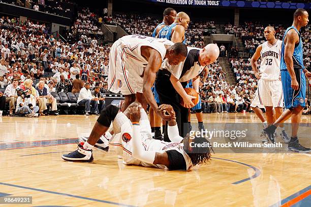 Theo Ratliff helps up Gerald Wallace of the Charlotte Bobcats in the game against the Orlando Magic in Game Three of the Eastern Conference...