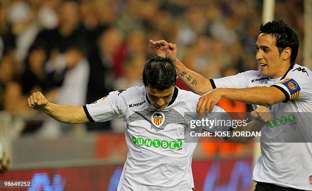 Valencia's forward David Villa celebrates his goal against Deportivo Coruna with teammate Vicente Rodiguez during their Spanish league football match...