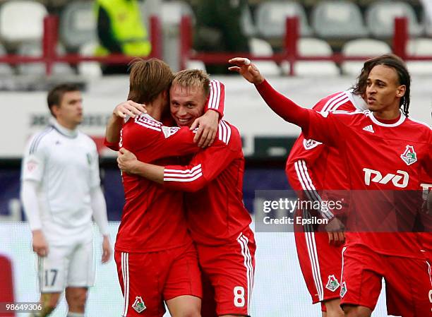 Denis Glushakov , Peter Odemwingie and Dmitri Sychev of FC Lokomotiv Moscow celebrate after scoring a goal during the Russian Football League...