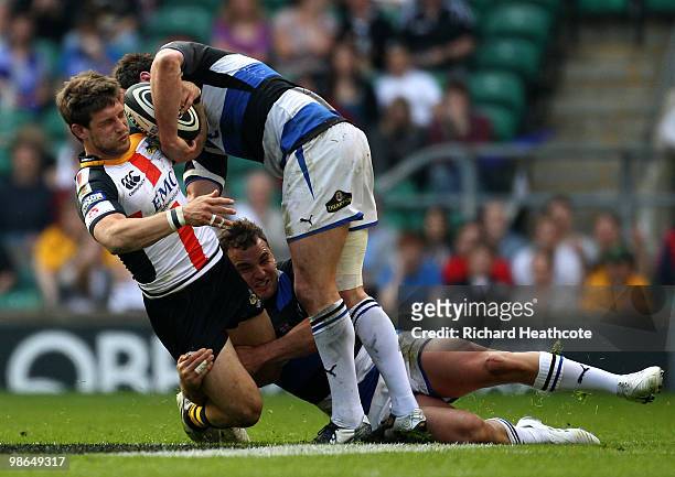 Dominic Waldouck of Wasps is tackled by Olly Barkley and Butch James of Bath during the Guinness Premiership St George's Day Game between London...