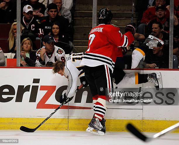 Brent Seabrook of the Chicago Blackhawks checks Martin Erat of the Nashville Predators into the boards in Game Five of the Western Conference...