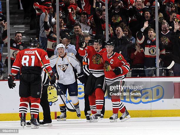 Tomas Kopecky of the Chicago Blackhawks celebrates with teammate Jonathan Toews after scoring against the Nashville Predators, as Ryan Suter of the...