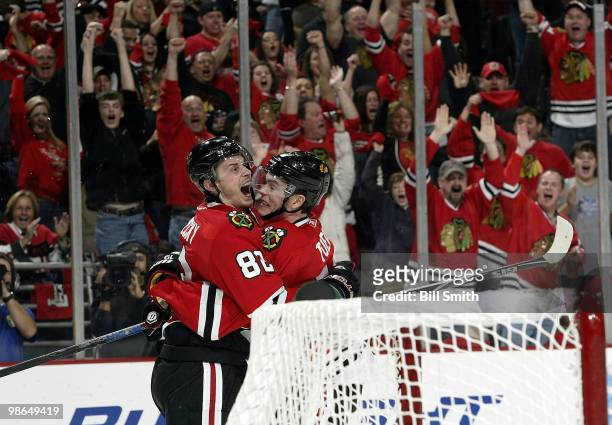 Tomas Kopecky of the Chicago Blackhawks celebrates with teammate Jonathan Toews after scoring against the Nashville Predators at Game Five of the...