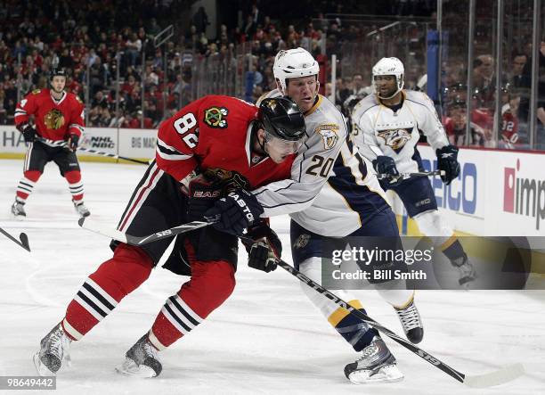 Tomas Kopecky of the Chicago Blackhawks and Ryan Suter of the Nashville Predators push into each other as they watch the puck at Game Five of the...