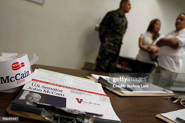 Voter registration forms sit on a table at a town hall meeting with U.S. Sen. John McCain during a campaign stop at Pima Community College on April...