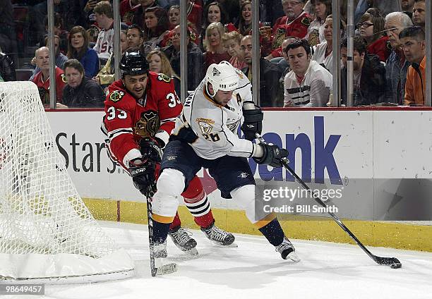 Steve Sullivan of the Nashville Predators grabs the puck as Dustin Byfuglien of the Chicago Blackhawks follows behind at Game Five of the Western...