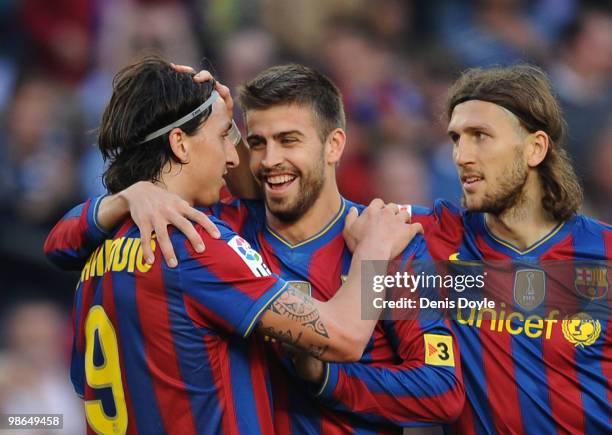 Zlatan Ibrahimovic of Barcelona is congratulated by Gerard Pique and Dimitro Chygrynski after he scored his team's third goal during the La Liga...