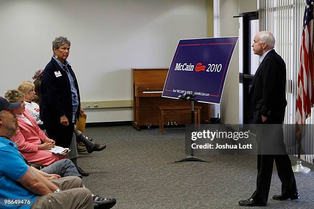 Sen. John McCain listens to a question from a supporter during a town hall meeting on a campaign stop at Pima Community College April 24, 2010 in...