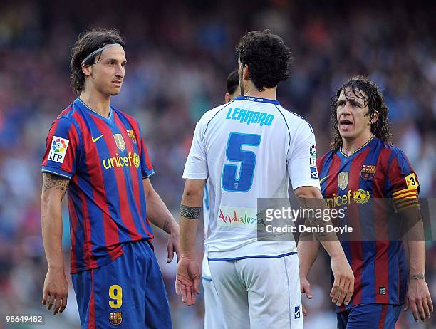 Zlatan Ibrahimovic and Carles Puyol of Barcelona argue with Leandro Gioda of Xerez CD during the La Liga match between Barcelona and Xerez CD at Camp...