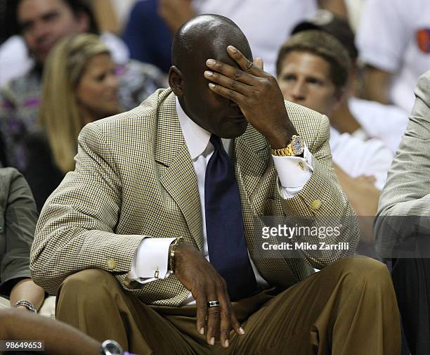 Charlotte Bobcats owner Michael Jordan wipes his forehead while watching the action during Game Three of the Eastern Conference Quarterfinals between...
