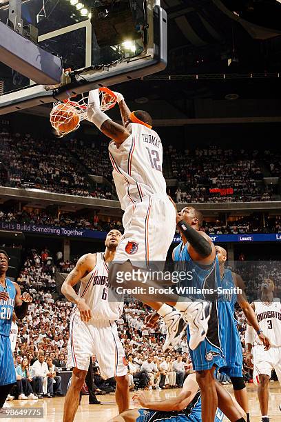 Tyrus Thomas of the Charlotte Bobcats dunks against Dwight Howard of the Orlando Magic in Game Three of the Eastern Conference Quarterfinals during...