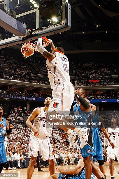 Tyrus Thomas of the Charlotte Bobcats dunks against Dwight Howard of the Orlando Magic in Game Three of the Eastern Conference Quarterfinals during...