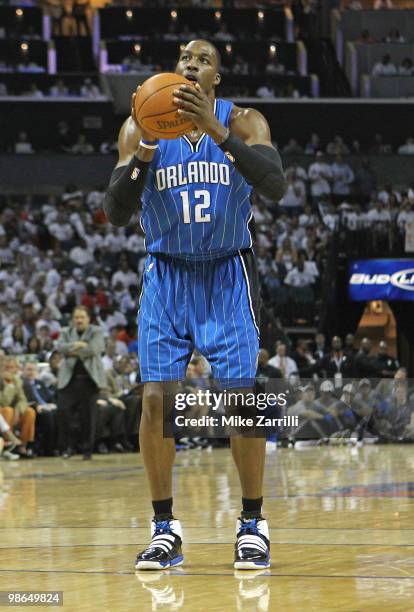 Center Dwight Howard of the Orlando Magic gets set to shoot a free throw during Game Three of the Eastern Conference Quarterfinals against the...