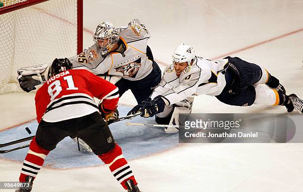 Marian Hossa of the Chicago Blackhawks scores the game-winning goal in overtime as Pekka Rinne and Shea Weber of the Nashville Predators dive to try...