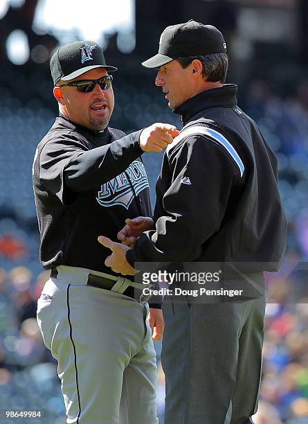 Manager Fredi Gonzalez of the Florida Marlins questions a first inning double play call with second base umpire Angel Hernandez against the Colorado...