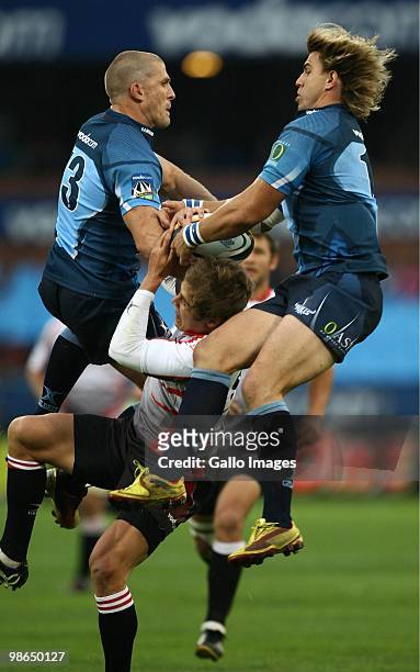 Jaco Pretorius and Wynand Olivier jump Michael Killian during the Super 14 match between Vodacom Bulls and Auto and General Lions from Loftus Stadium...