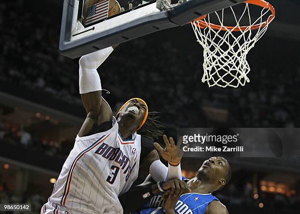 Forward Gerald Wallace of the Charlotte Bobcats goes up for a shot while center Dwight Howard of the Orlando Magic defends him during Game Three of...