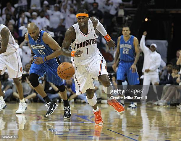 Guard Stephen Jackson of the Charlotte Bobcats chases a loose ball while guard Vince Carter of the Orlando Magic pursues during Game Three of the...